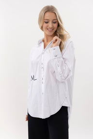 Woman wearing a white blouse with a logo on a white background