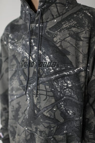 Camouflage hoodie with 'Good Goods' branding on a neutral background