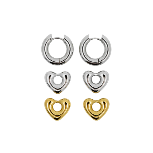 Set of heart-shaped earrings in silver and gold on a white background