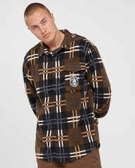 Man wearing a plaid shirt with a logo on a white background