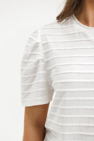 White striped shirt worn by a person on a white background