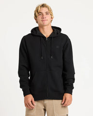 Person wearing a black hoodie with a small logo on a white background