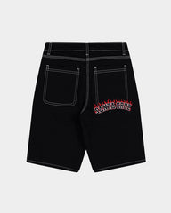 Black shorts with a red and white logo on the back pocket against a light gray background