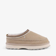 Beige slip-on shoe with decorative trim on a white background