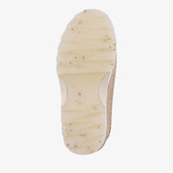 Close-up of a beige shoe sole on a white background