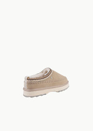 Beige slip-on shoe with white sole on a white background