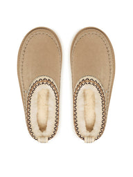 Pair of beige slippers with fur lining on a white background