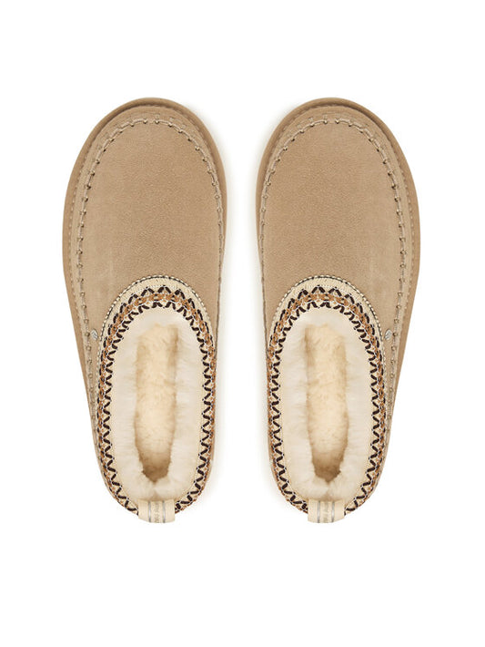 Pair of beige slippers with fur lining on a white background