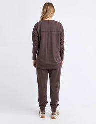 Person wearing a brown tracksuit on a white background