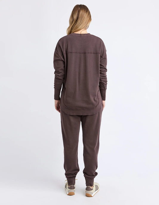 Person wearing a brown tracksuit on a white background