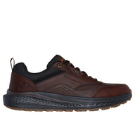 Brown sneaker with black sole on a white background