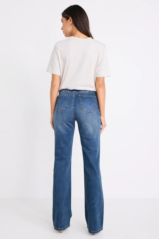 Person wearing blue jeans and a white t-shirt on a white background