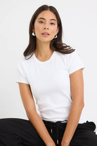 Woman wearing a plain white t-shirt against a white background