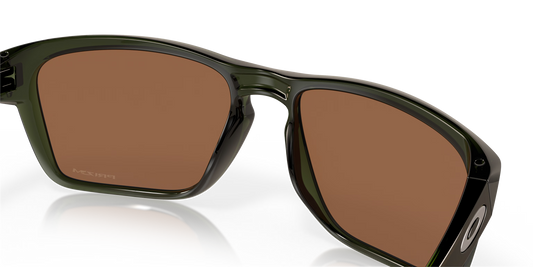 Sunglasses with brown lenses and green frame on a black background