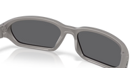 Gray sunglasses with dark lenses on a white background