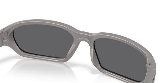 Gray sunglasses with dark lenses on a white background