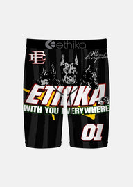 Black athletic shorts with a bold graphic design featuring three dog illustrations, the word 'ETHIKA' in large white and red letters, the phrase 'WITH YOU EVERYWHERE' in green, and the number '01' on the leg. The brand name 'ethika' is visible on the waistband.