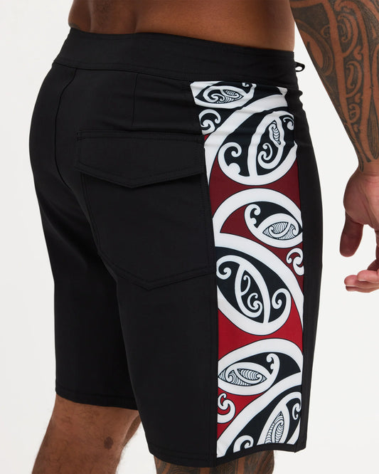 Black boardshort with Maori design along the side of short 
