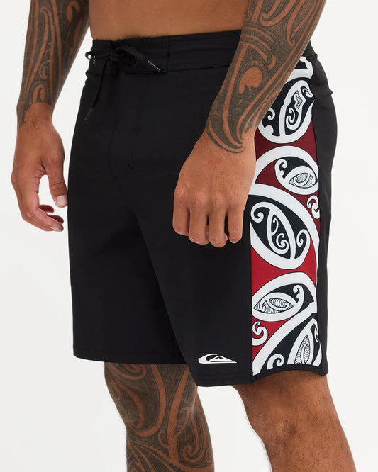 Black boardshort with Maori design along the side of short 