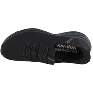 Black Skechers slip-in shoe on a white background
