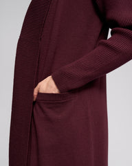 Maroon cardigan worn by a person on a light gray background