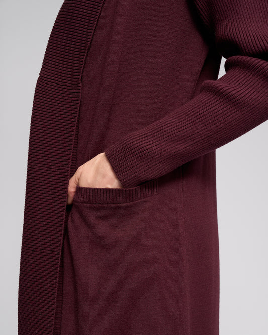 Maroon cardigan worn by a person on a light gray background
