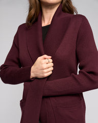 Maroon cardigan worn by a person on a light gray background