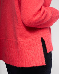 Close-up of a bright pink sweater with a blurred background