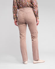 Person wearing beige pants with a patterned shirt on a white background