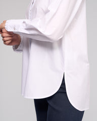 White shirt being held up against a plain background