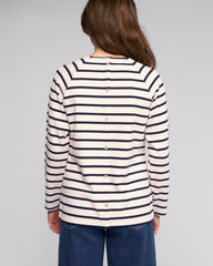 Person wearing a striped shirt with long sleeves on a plain background