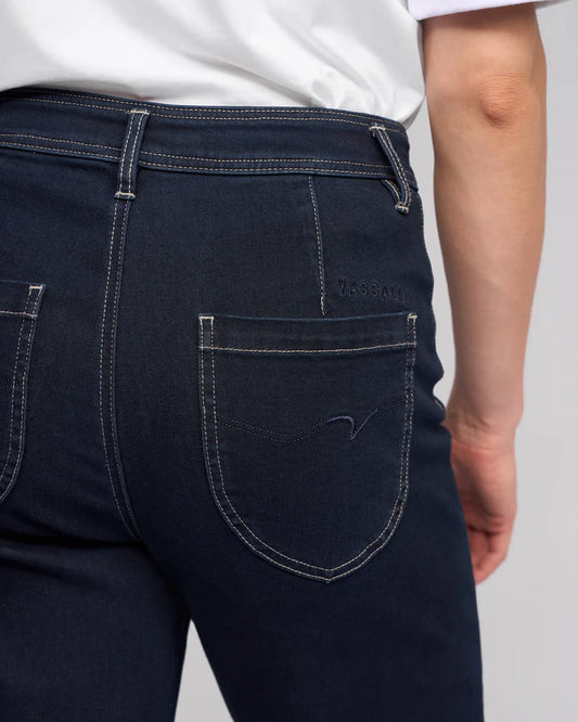 Dark blue jeans with a visible brand logo on a plain background