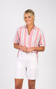 Woman wearing the Vassalli White Denim Shorts with a striped shirt and white background