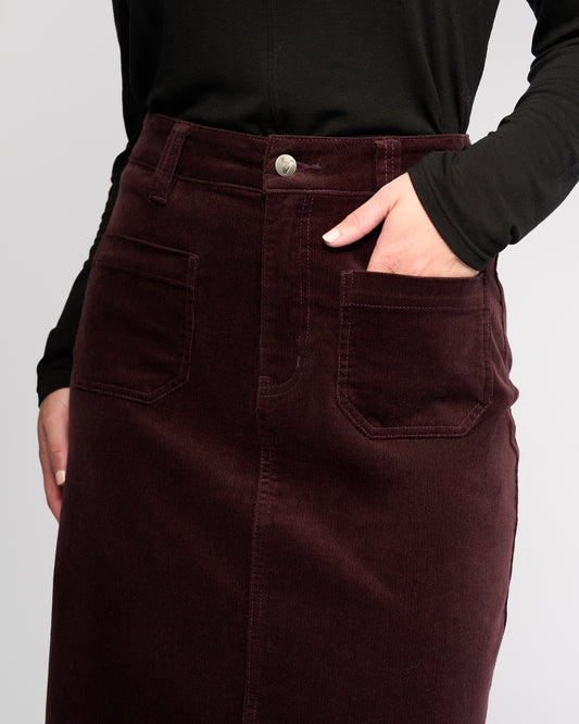 Brown corduroy skirt worn by a person on a light gray background
