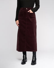 Person wearing a burgundy corduroy skirt on a white background