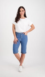 Woman wearing a white t-shirt and Vassalli blue denim shorts on a white background