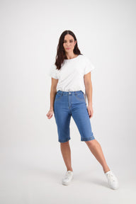 Woman wearing a white t-shirt and Vassalli blue shorts on a white background