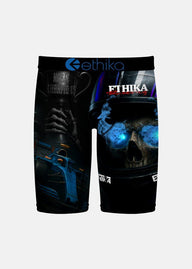 Black athletic shorts featuring a graphic print of a skull in a racing helmet with blue glowing eyes and a trophy cup, with the brand name 'ethika' printed on the waistband and leg.
