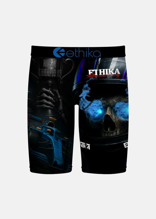 Black athletic shorts featuring a graphic print of a skull in a racing helmet with blue glowing eyes and a trophy cup, with the brand name 'ethika' printed on the waistband and leg.