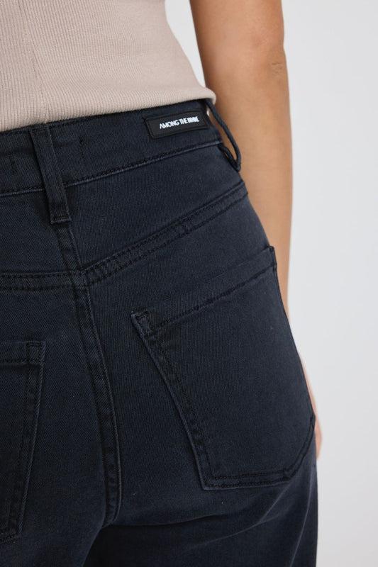 Black pants with a brand label on a white background