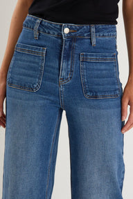 Close-up of blue jeans with a plain background