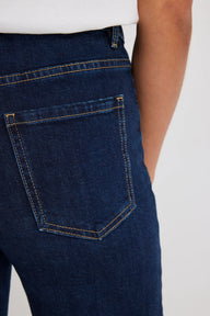 Close-up of blue jeans with a white background